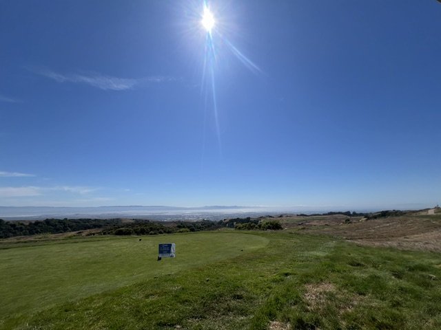 Hilltop tee at Stonebrae Country Club with sweeping Bay Area views under a bright sky