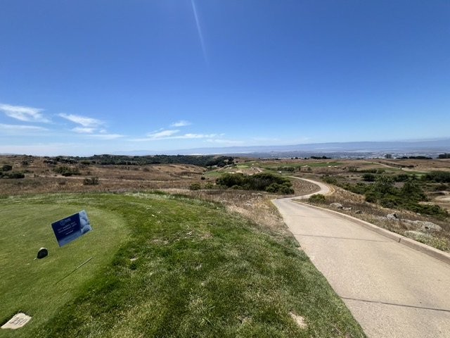 Tee box and cart path winding through native grasses at Stonebrae Country Club in the Hayward hills